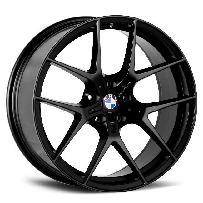 The image features a black, multi-spoke BMW alloy wheel resting on a plain white background. The BMW logo is prominently displayed at the center.