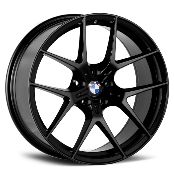 The image features a black, multi-spoke BMW alloy wheel resting on a plain white background. The BMW logo is prominently displayed at the center.