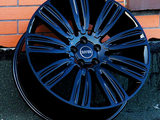 A glossy black alloy wheel featuring 
