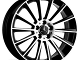 A black and silver alloy wheel with multi-spoke design, featuring a central logo of three-pointed star and 