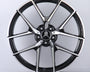 A metallic Mercedes-Benz wheel rim with five intricate spokes showcases the AMG logo, set against a plain white background.