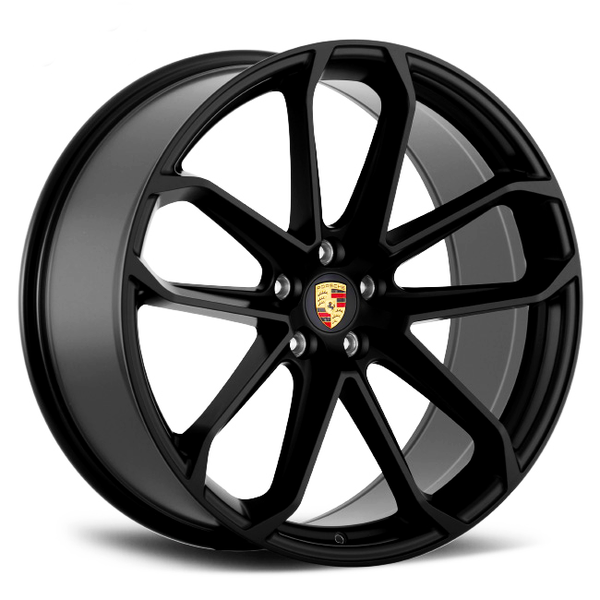 A black alloy wheel with a five double-spoke design, featuring the Porsche crest at its center, is positioned on a white background.