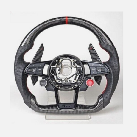 A carbon fiber car steering wheel, with multiple buttons including “VIEW” and “MENU” on the left and “RES” on the right, is displayed on a stand with a minimal background.