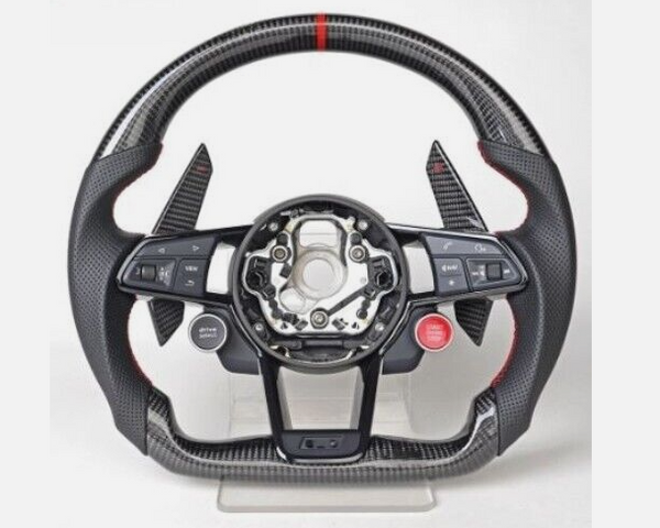 A carbon fiber steering wheel, featuring electronic controls and paddle shifters, rests on a stand. It includes buttons labeled "MODE," "RES," "SET," "VIEW," and a red "START ENGINE STOP" button.