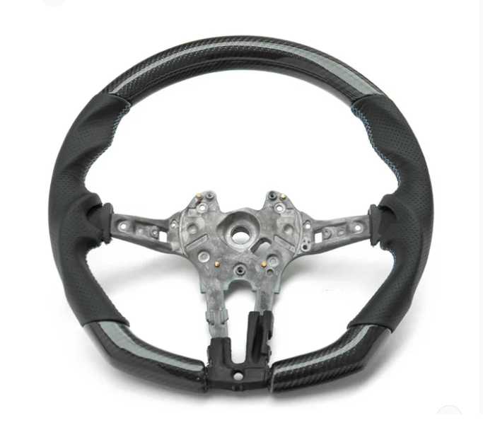 A partially assembled car steering wheel is shown, featuring a metallic central frame with exposed wiring, surrounded by a two-tone black and grey perforated leather grip, against a plain white background.