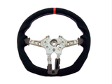 A steering wheel with a black, fabric-covered rim and a red stripe at the top, features a metallic core with attachment points, against a plain white background.