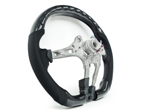 A carbon fiber car steering wheel frame with black perforated grips sits on a plain white background, showcasing exposed metal structure and colorful stitching on the grips.