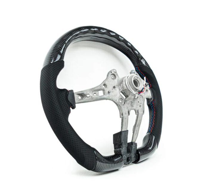 A carbon fiber car steering wheel frame with black perforated grips sits on a plain white background, showcasing exposed metal structure and colorful stitching on the grips.
