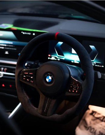 Steering wheel with a BMW logo is centered, surrounded by digital screens displaying vehicle information, inside a modern car's interior. Ambient lighting and dashboard controls enhance the sleek, futuristic environment.