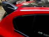 A red car features a black spoiler with 