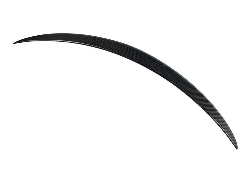 A curved carbon fiber surfboard fin, sleek and streamlined, appears against a plain white background, highlighting its thin, aerodynamic design.