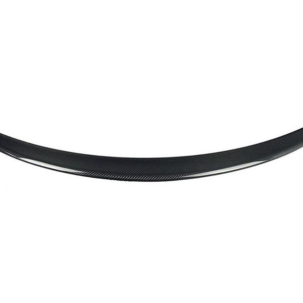 A curved carbon-fiber car spoiler rests on a plain white background, showcasing its sleek, aerodynamic form. No text is present.