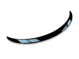 Curved black object with two light blue reflective sections, resembling a car spoiler or aerodynamic component, set against a plain white background.