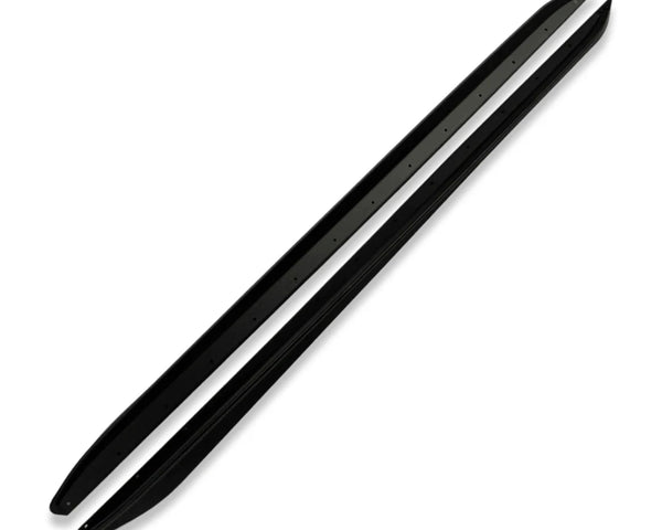 Two black snowmobile ski runners rest parallel on a plain white background. They feature slightly upturned ends with small holes regularly spaced along their length for mounting.