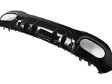 A glossy black car bumper with angular fins and aerodynamic design, lying on a plain white background.