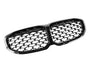 A shiny black dual-section car grille, featuring a diamond pattern, is set against a plain white background, emphasizing its sleek and glossy design.