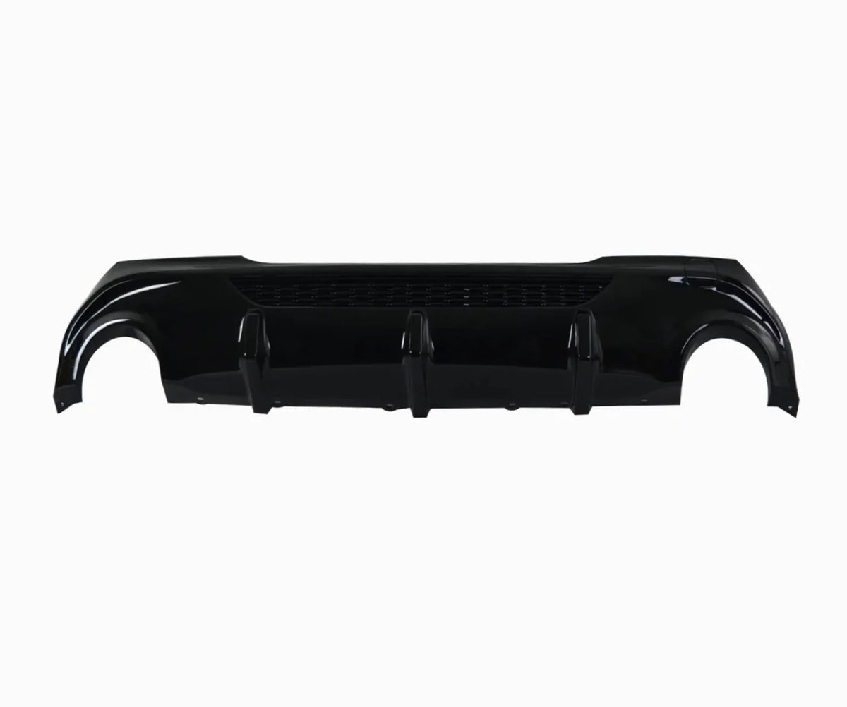 A glossy black car rear bumper diffuser lies horizontally. It features three vertical fins and a mesh section, isolated against a plain white background.