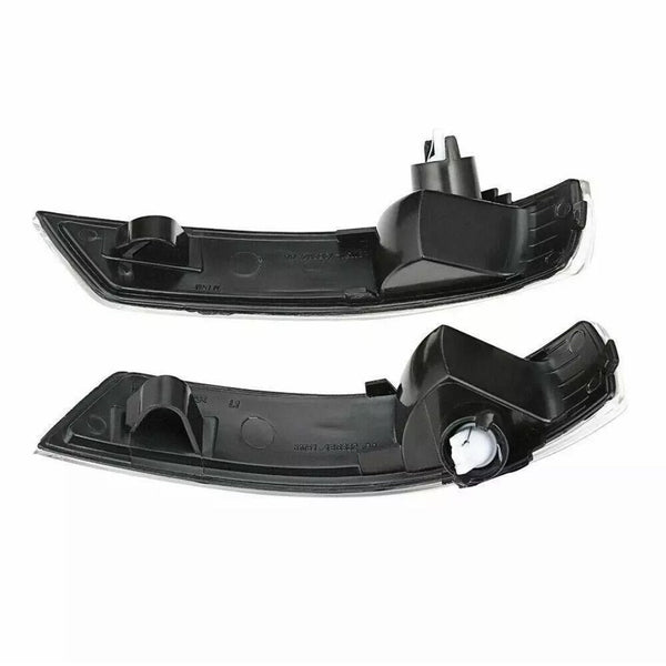 Two black plastic car light covers, each with a curved shape and mounting points, are positioned horizontally on a white background.
