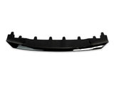 A black car bumper lip lies horizontally, with multiple mounting tabs along its top edge, set against a plain white background.