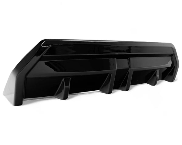 A sleek, black car diffuser sits on a white background, featuring angular design elements and aerodynamic fins, suggesting use in automotive rear bumper applications.