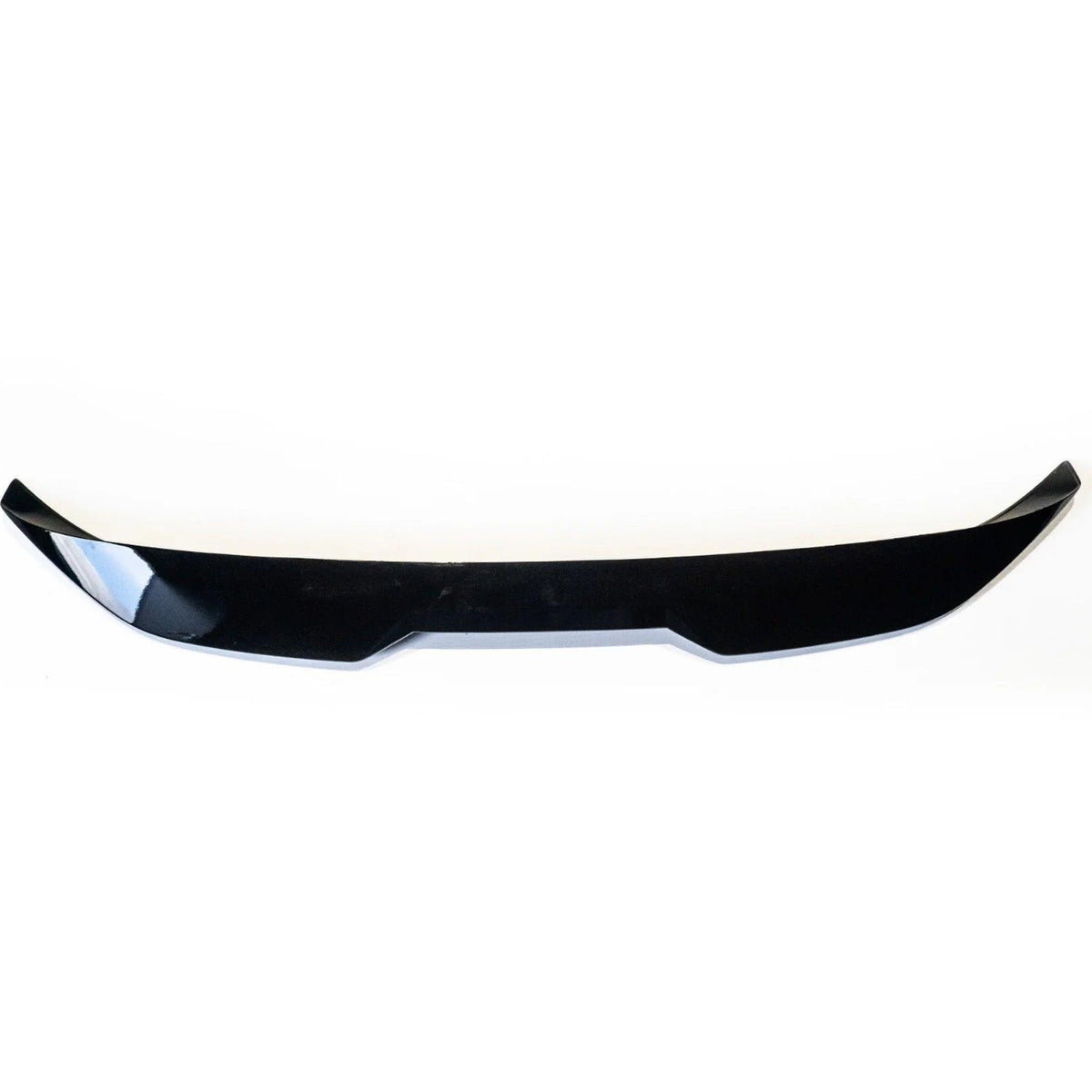 Black, glossy car spoiler positioned horizontally, featuring a slightly curved shape with angular edges, set against a plain white background.