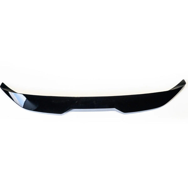 Black, glossy car spoiler positioned horizontally, featuring a slightly curved shape with angular edges, set against a plain white background.