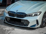 A sleek, gray BMW car's front view with a large grille and angular headlights, parked on a textured asphalt surface.