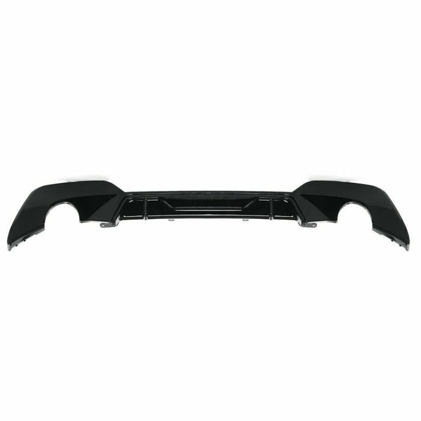 A black car bumper diffuser lies flat against a white background, showcasing cutouts for exhaust pipes and a sleek, aerodynamic design.