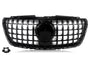 A black car grille features a grid design with a central circular emblem area, set against a white background. A detached rectangular component is located in the lower left corner.