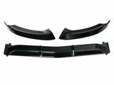 Three black car bumper splitters are displayed; two are curved, and one is long and straight, with fins. They rest against a plain white background, suggesting an auto accessory context.