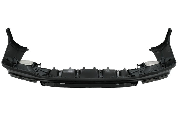 A black plastic car bumper, featuring mounting brackets and slots, is positioned in an isolated, white background setting.