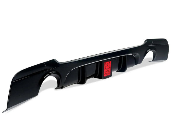 Black car diffuser with integrated red brake light, featuring curved cutouts and aerodynamic fins. Positioned on a white background, highlighting its sleek design and functional automotive use.