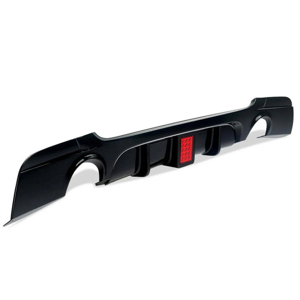 Black car diffuser with integrated red brake light, featuring curved cutouts and aerodynamic fins. Positioned on a white background, highlighting its sleek design and functional automotive use.