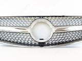 A shiny car grille features a prominent circular center, intricate mesh pattern, and chrome accents, positioned against a plain white background.