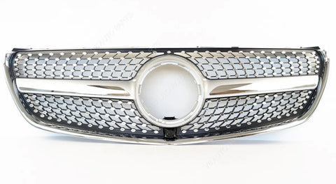 A shiny car grille features a prominent circular center, intricate mesh pattern, and chrome accents, positioned against a plain white background.