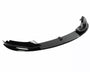 A sleek, black car front lip spoiler is resting on a plain, white background. It features a curved aerodynamic design, often used for reducing drag and enhancing vehicle performance.