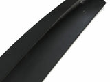 A sleek, black car spoiler with small mounting holes lies on a white background, showcasing its smooth surface and aerodynamic design.
