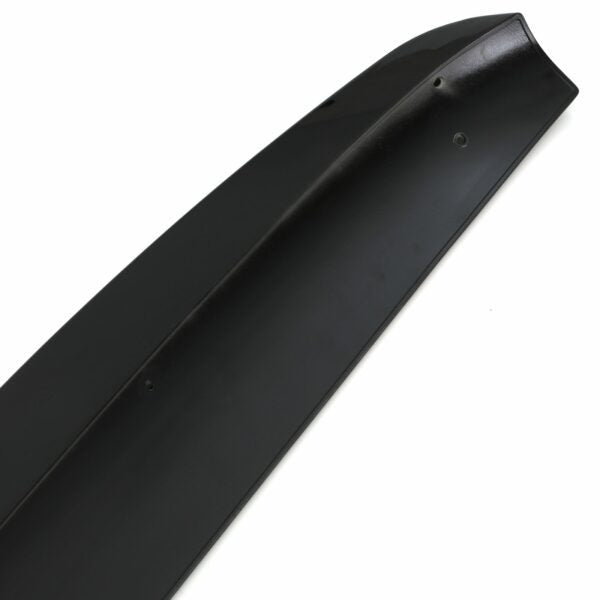 A sleek, black car spoiler with small mounting holes lies on a white background, showcasing its smooth surface and aerodynamic design.