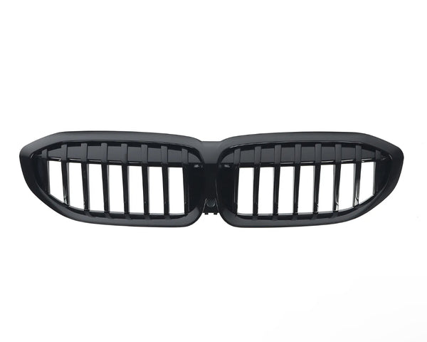 A glossy black car grille with vertical slats, shaped in two connected oval sections, is isolated on a white background.