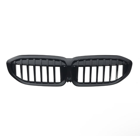 A glossy black car grille with vertical slats, shaped in two connected oval sections, is isolated on a white background.