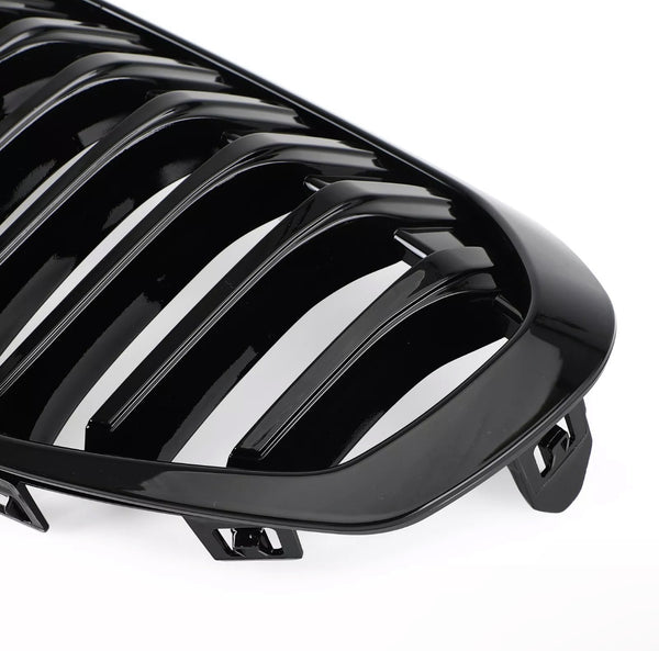 A glossy black car grille with multiple vertical slats is positioned against a plain white background, highlighting its sleek design and curved edges.