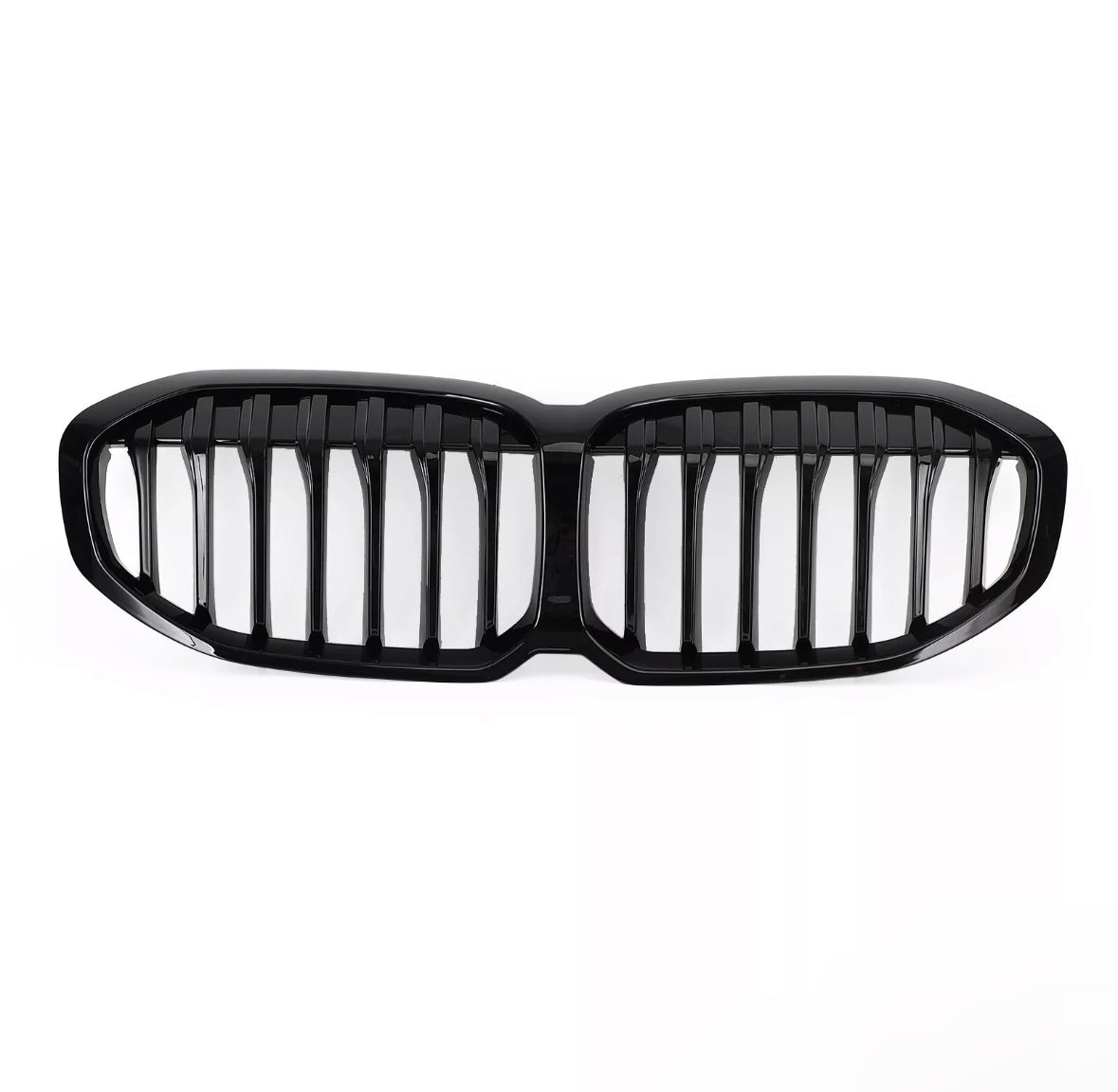 A glossy black car grille, featuring vertical slats, lies on a plain white background, designed to fit the front of a vehicle, enhancing its appearance and functionality.