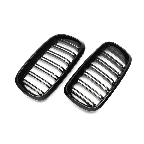 Two black automotive grille inserts, featuring horizontal bars, are placed against a plain white background, likely intended for a car's front end.