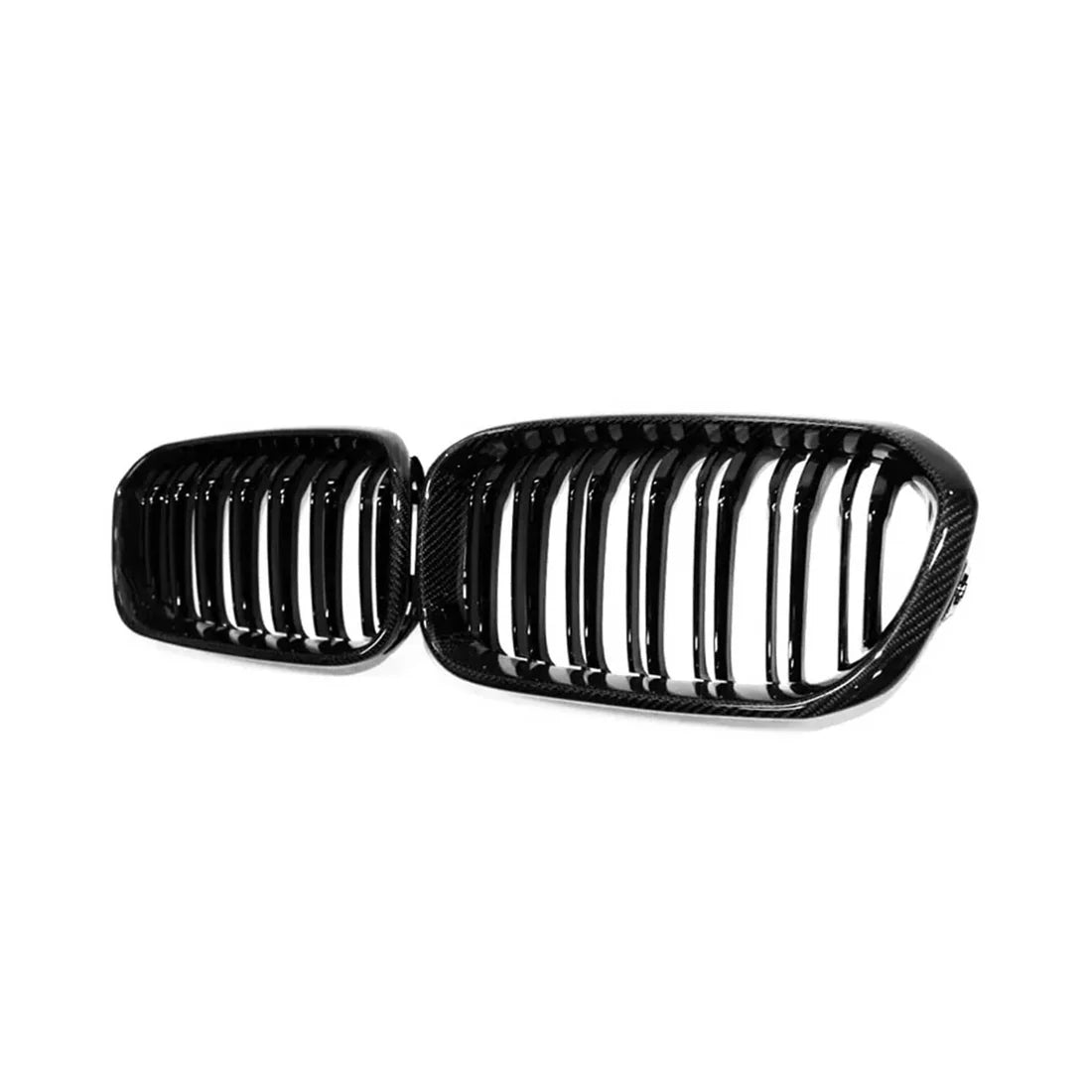 Two shiny black car grilles with vertical slats, placed side by side against a plain white background.