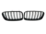 Two black, oval car grille inserts with vertical slats are positioned side by side against a plain white background.