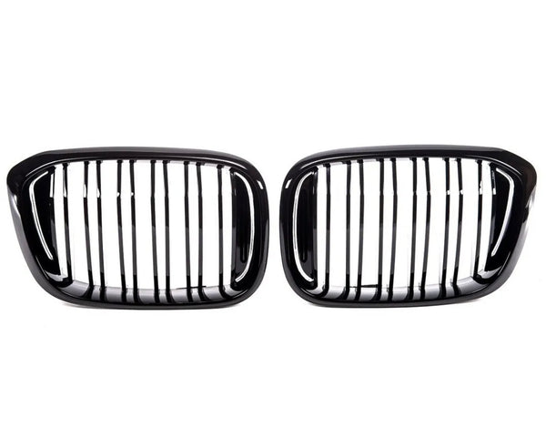 Two black car grilles with vertical slats, aligned side by side against a white background, commonly used as front-end design elements for vehicle air intake and styling.