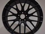 A black car wheel with multiple spokes displays the 