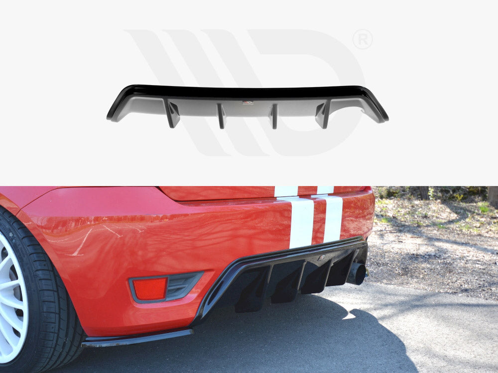 A black car diffuser is displayed. In use, it attaches to the rear of a red car with white racing stripes. The car is parked on a sunny street.