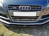 Car front features Audi grille with four rings, 