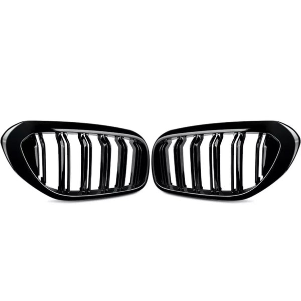 Two black car grille inserts with vertical slats are positioned symmetrically. They rest against a plain white background, showing a sleek, glossy finish.